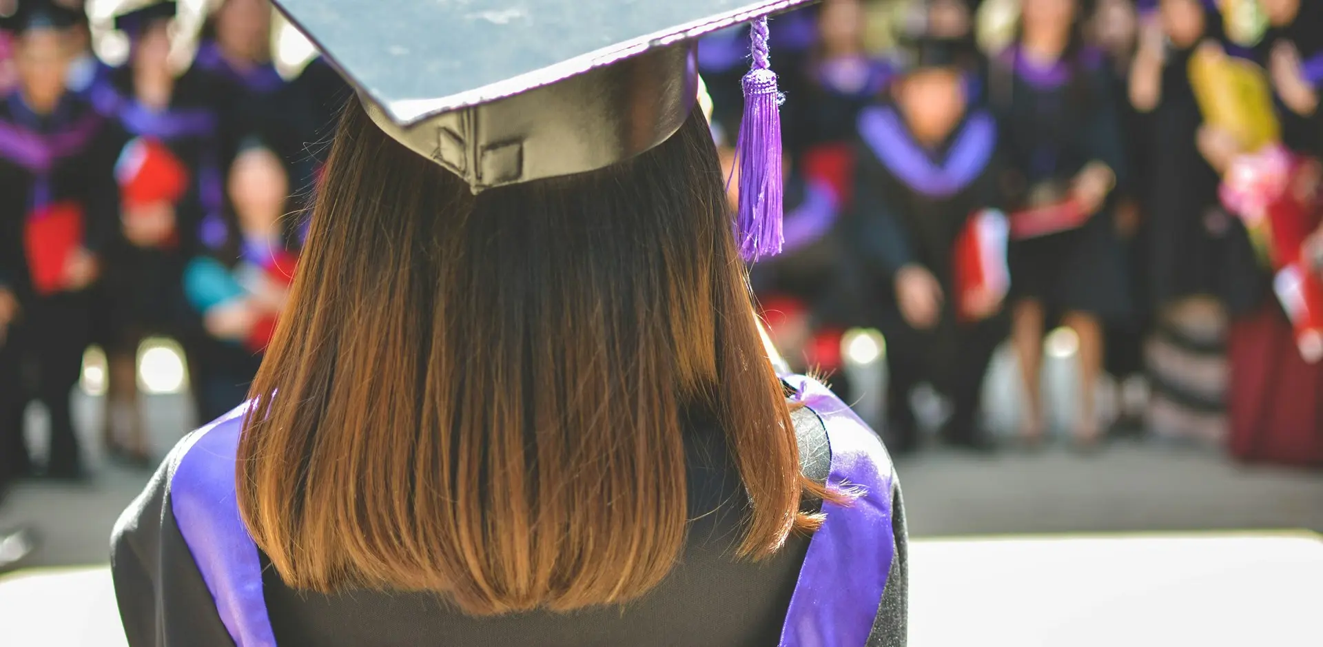 woman wearing academic cap and dress selective focus photography